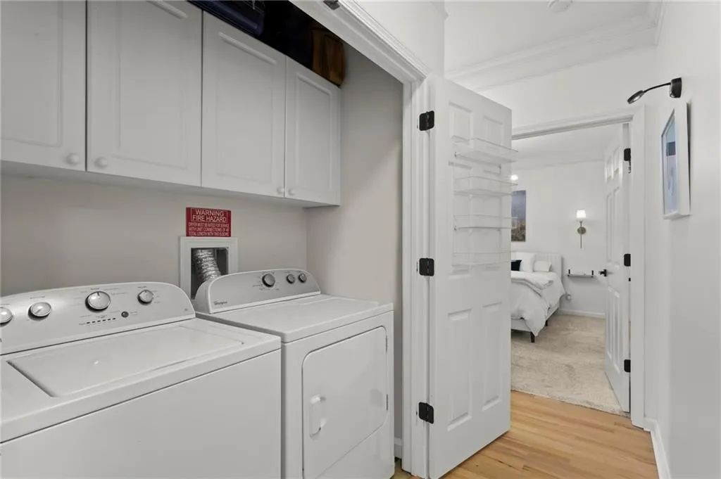 Laundry closet with custom cabinetry.