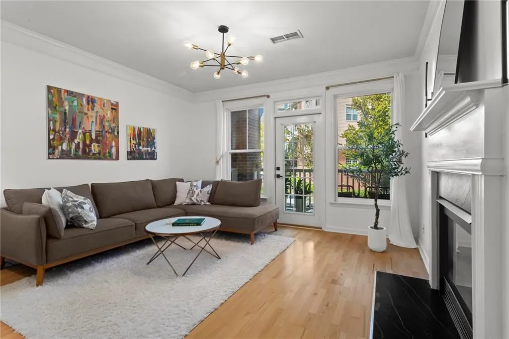 Living area with wood flooring and fireplace.