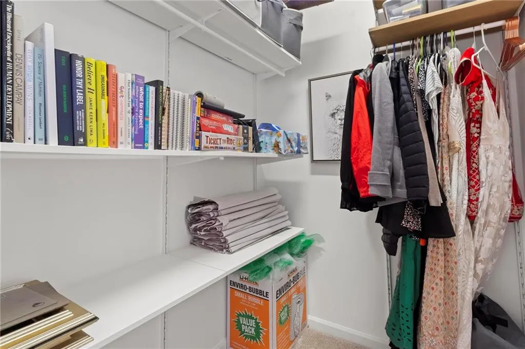 Spacious secondary walk-in close with custom shelving.