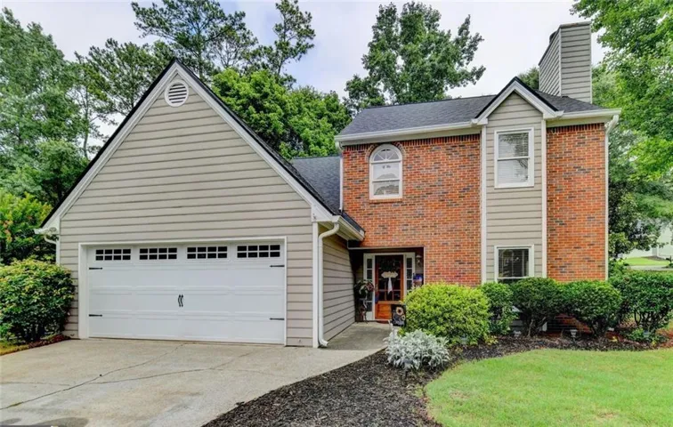 Brick and siding exterior with a two-car garage