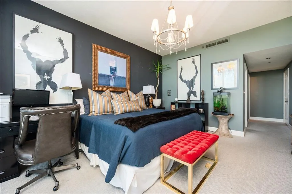 Bedroom with carpet flooring, a chandelier, and a desk