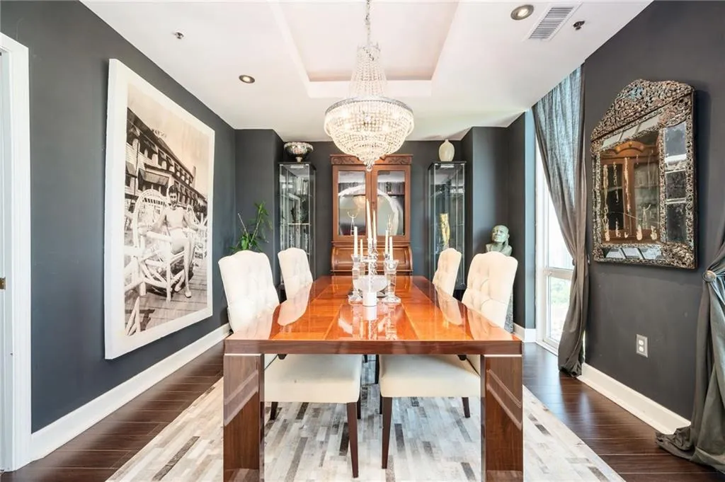Dining room with wood floors, and a raised ceiling