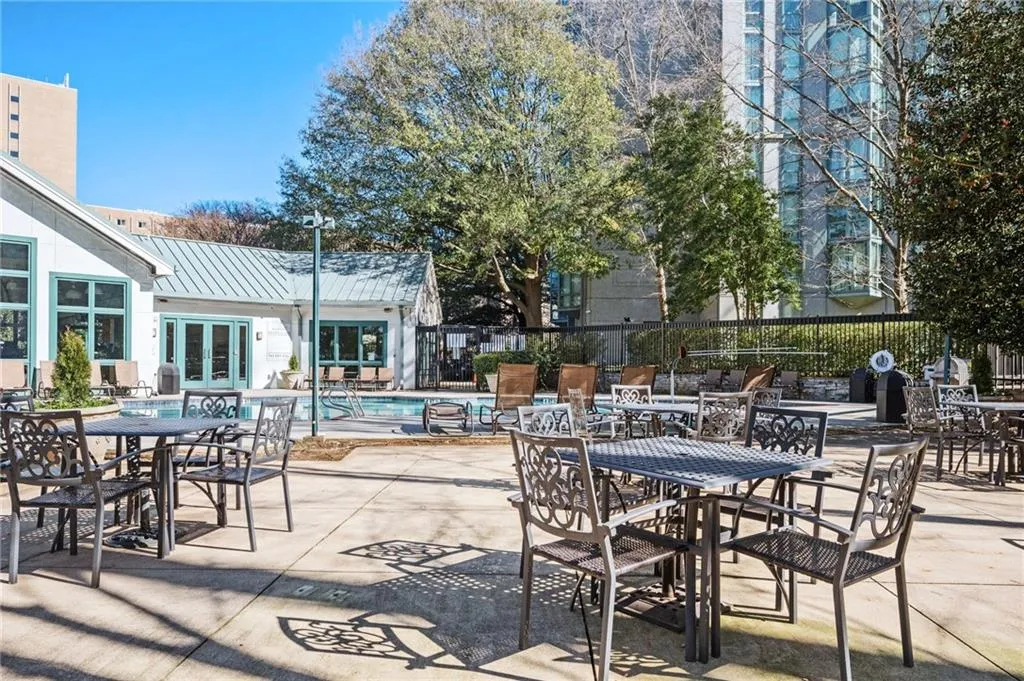 View of patio / terrace with french doors, a community pool, and outdoor dining space