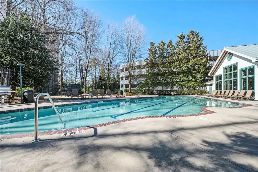 Community pool with a patio