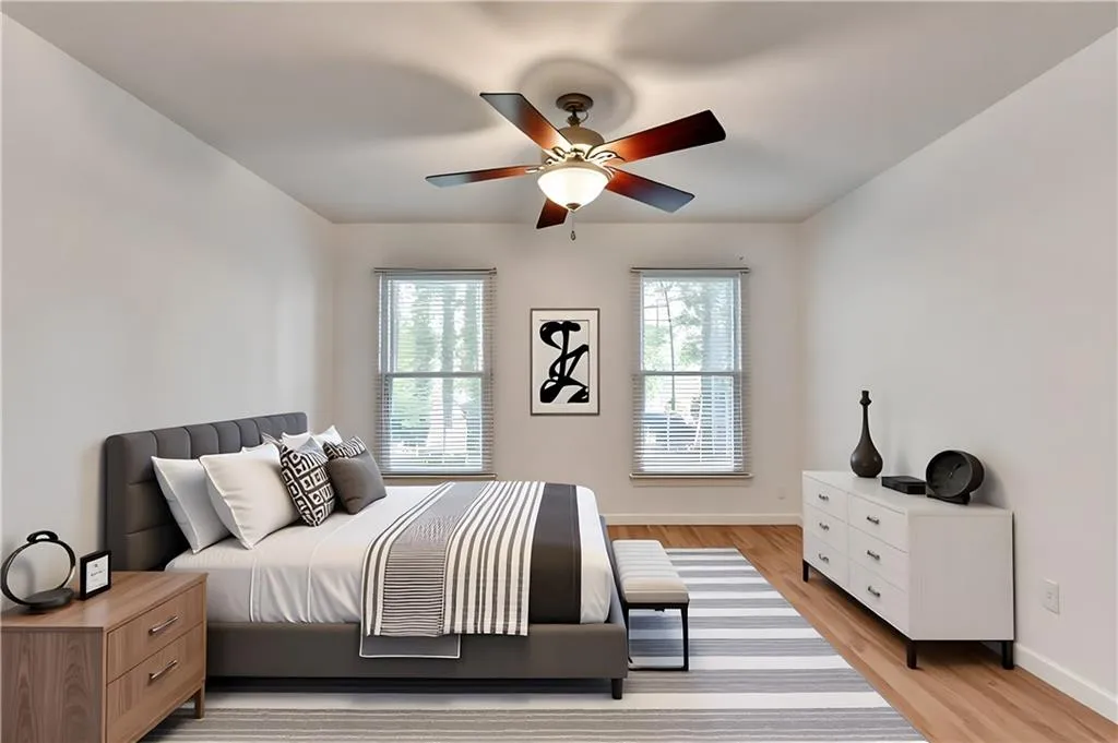 Bedroom featuring light wood-style floors and a ceiling fan