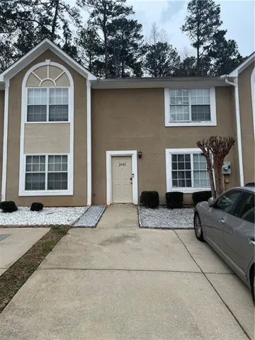 View of exterior entry with stucco siding