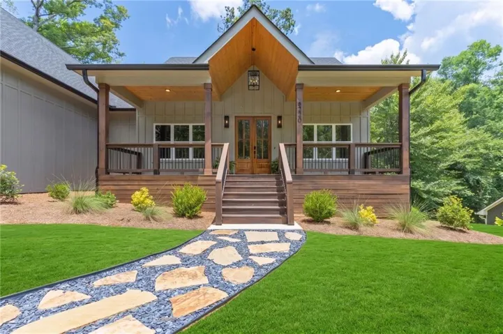 Exterior featuring a gabled front porch with wood plank ceiling and dark wood support columns