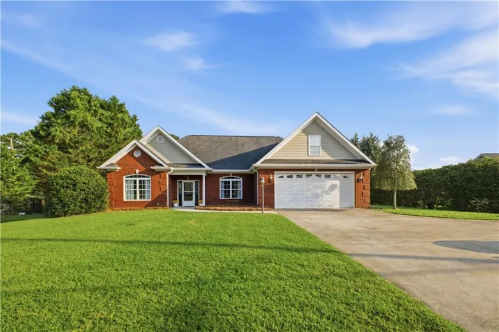 Brick exterior with gabled roof lines and light siding accents