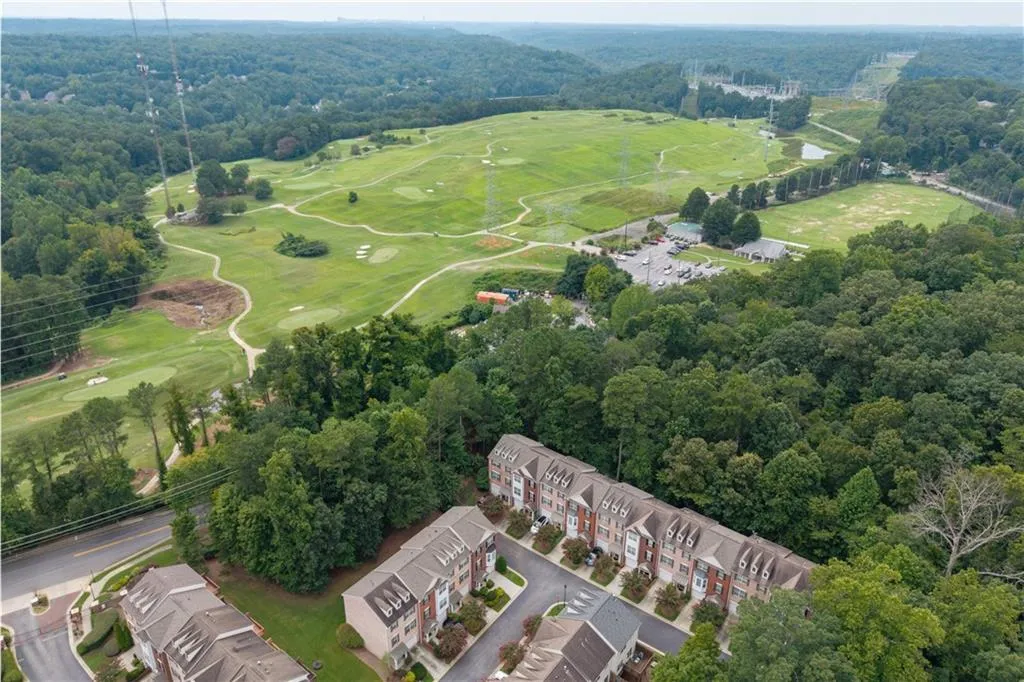 Aerial view of property's location to Steel Canyon Golf Club, an 18-hole public golf course with a heated driving range, individual & group classes and lush greenery.