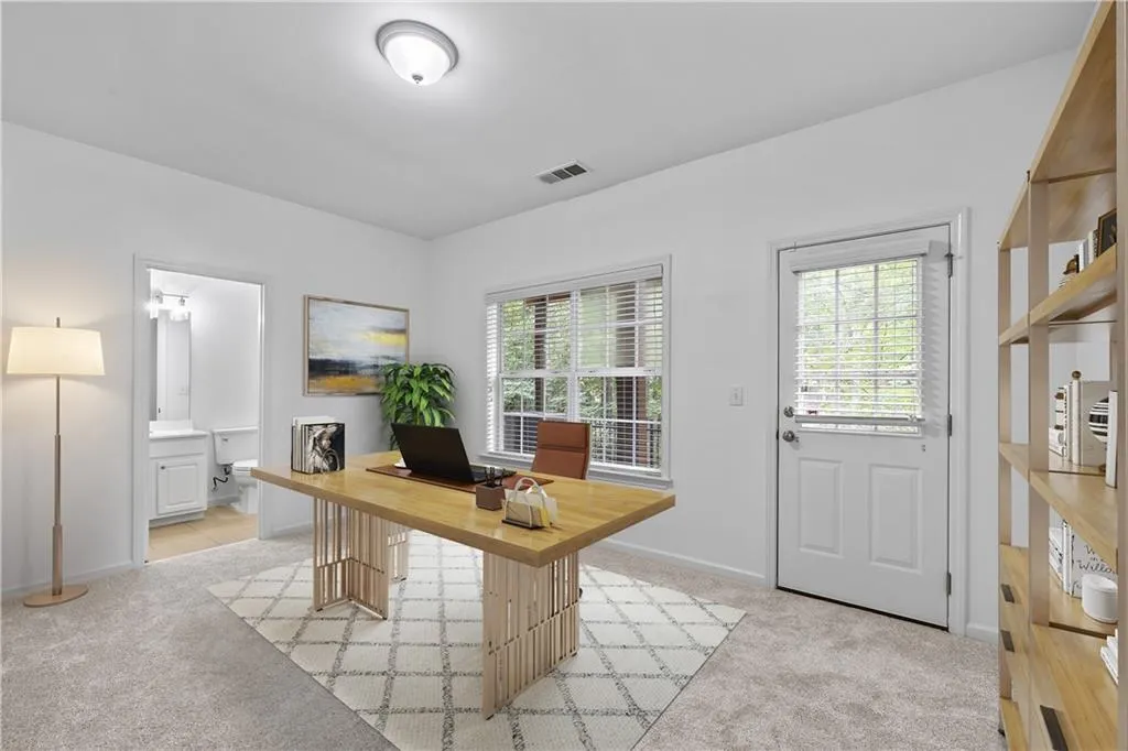 Lower-level flex ensuite. Virtually staged as a private office. Use space as a bedroom/guest suite, workout area or whatever your lifestyle requires.