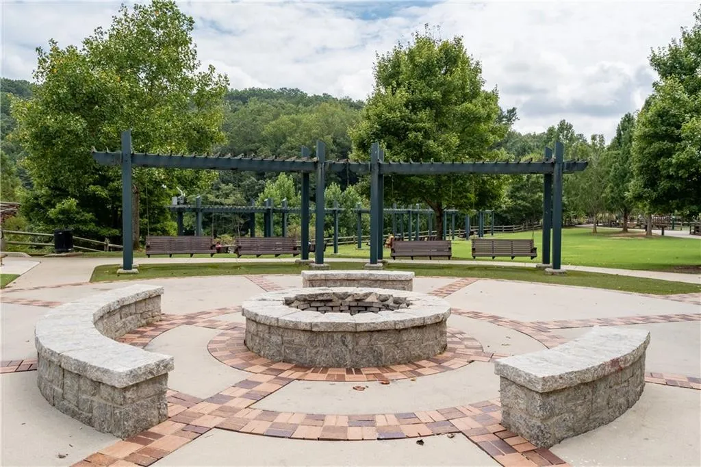 Fire pit for chilly days or evenings, spacious lawn for children to run and play, pergola and swings at Morgans Falls Overlook Park.