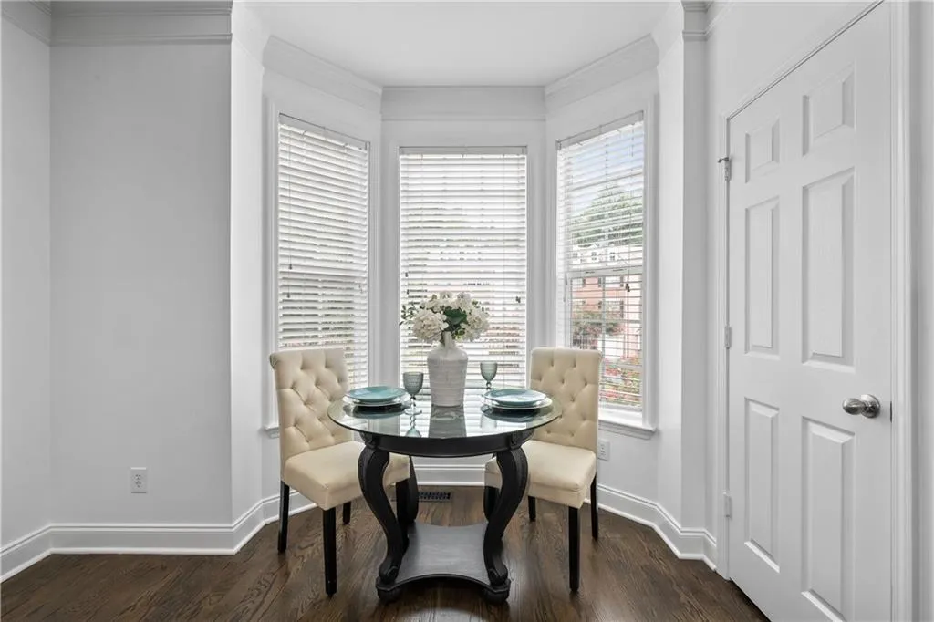 Spacious, bright, and elegant eat-in kitchen/dining area with large bay window providing ample natural light and a view of the outside.