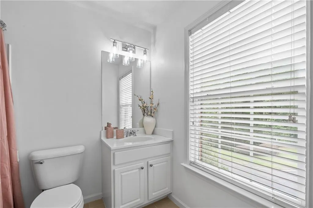 Charming second-floor ensuite bath is filled with natural light.