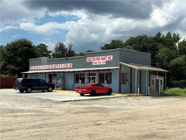 Single-story commercial building with light blue and gray exterior