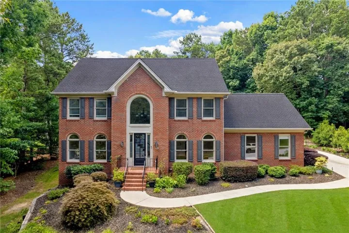 Brick exterior with a prominent arched window above the entry