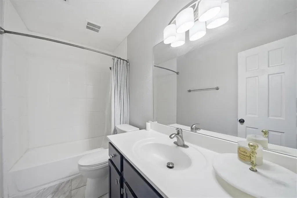 Full bath featuring vanity and shower / tub combo