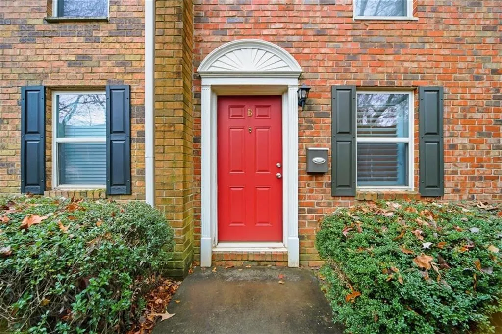 Doorway to property featuring brick siding