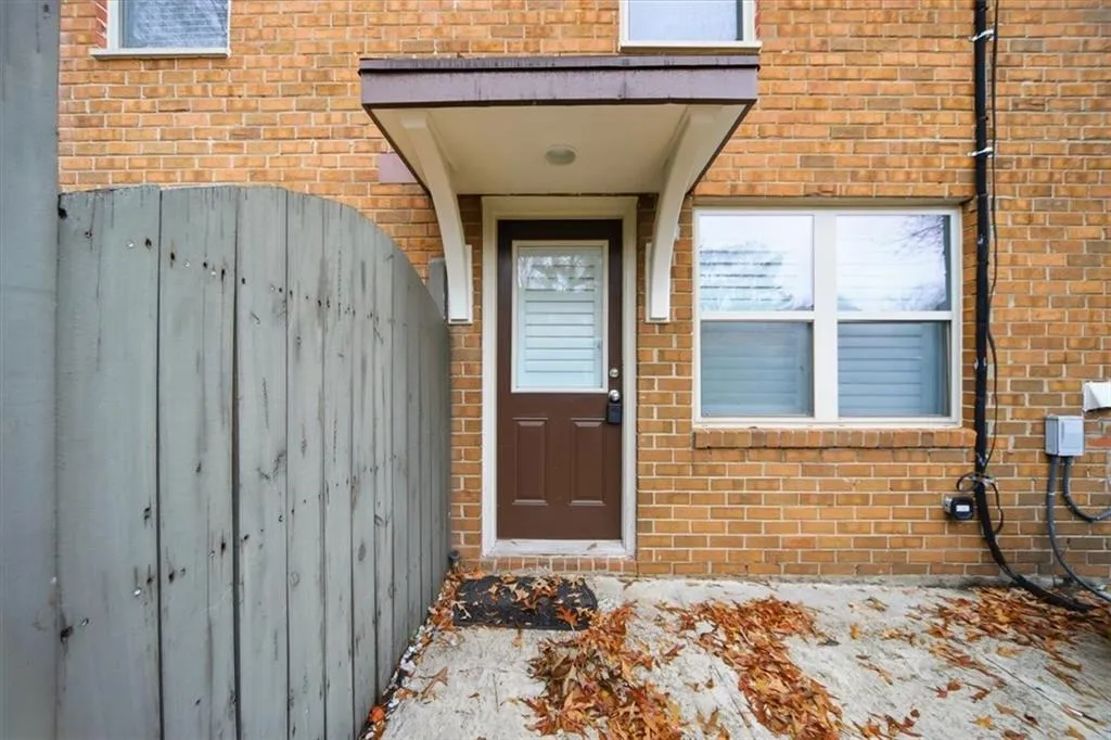 Doorway to property with brick siding
