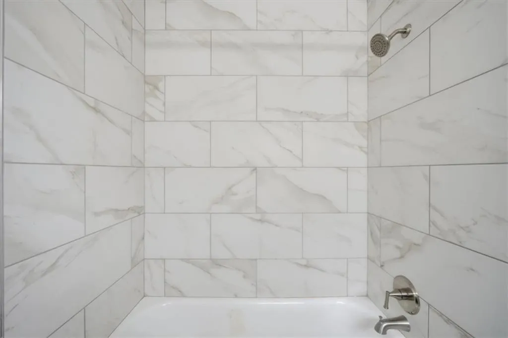 Full bath featuring washtub / shower combination