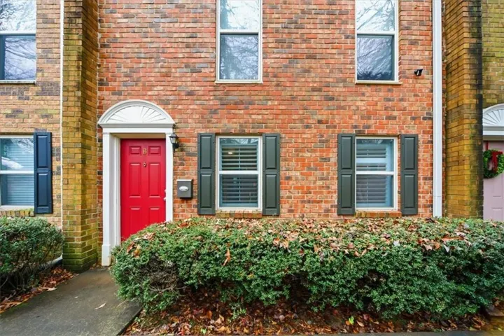 Property entrance featuring brick siding