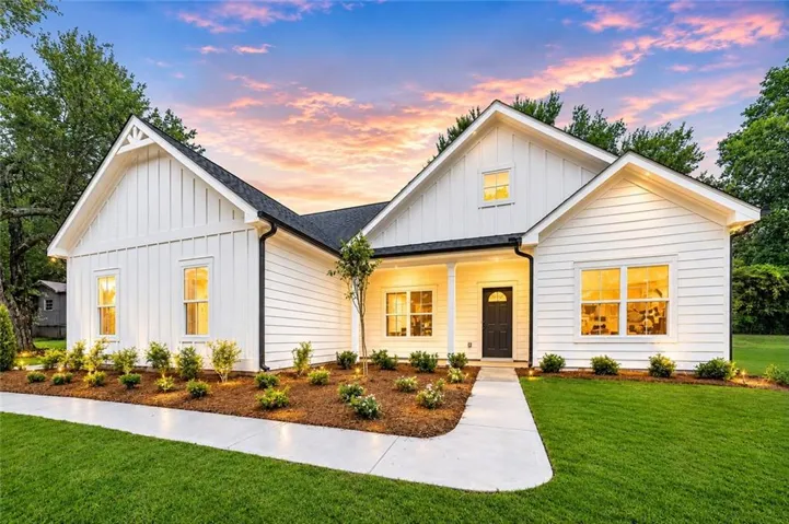 White board and batten and horizontal siding exterior with dark trim