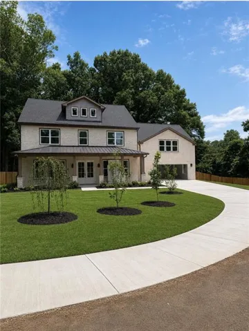 Two-story residence featuring a light-colored brick exterior, dark shingle roof, and dormer windows