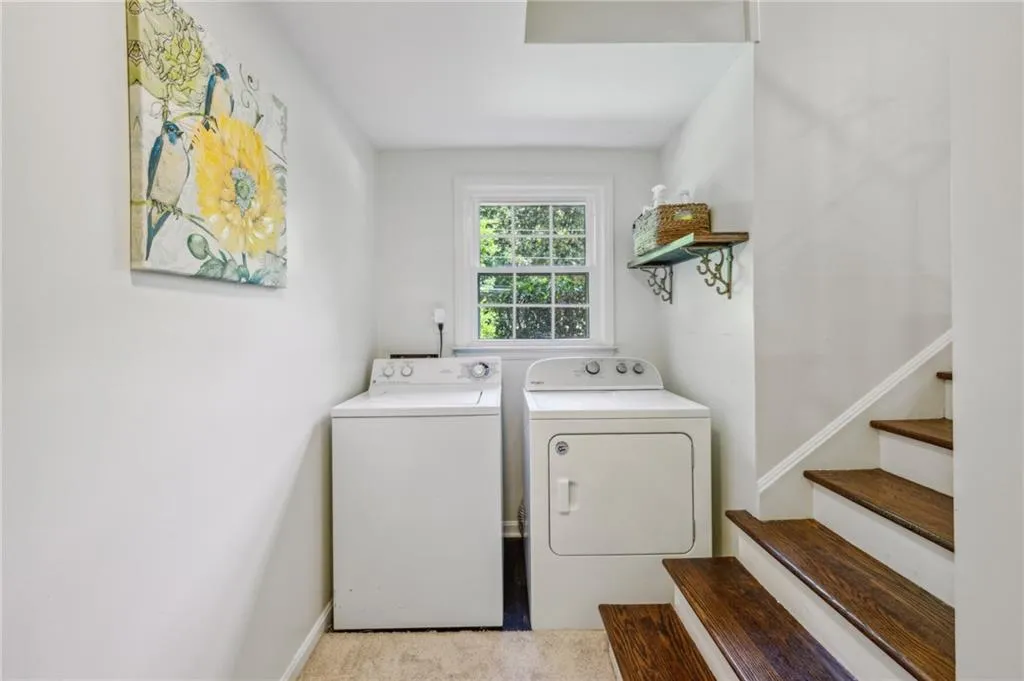 Washroom featuring washer and dryer and baseboards