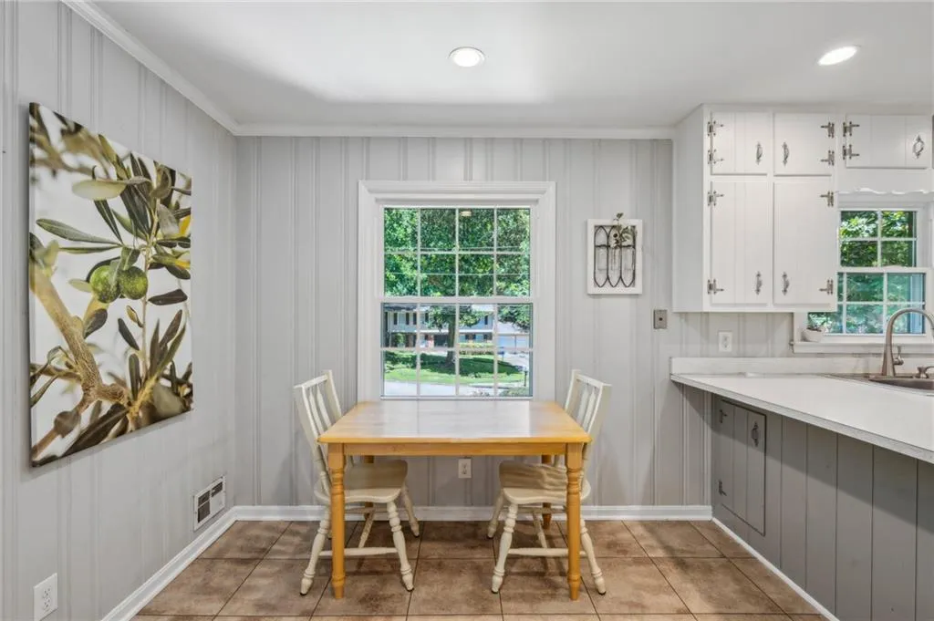 Dining area featuring light tile patterned floors and recessed lighting