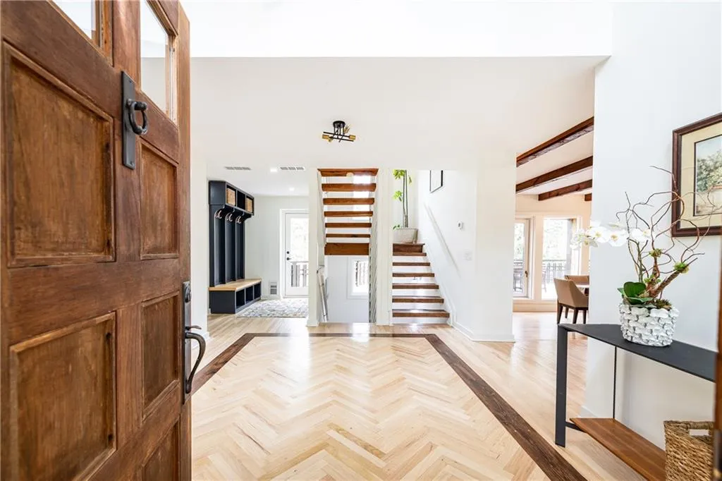 Foyer entrance featuring parquet flooring and inlaid floor details