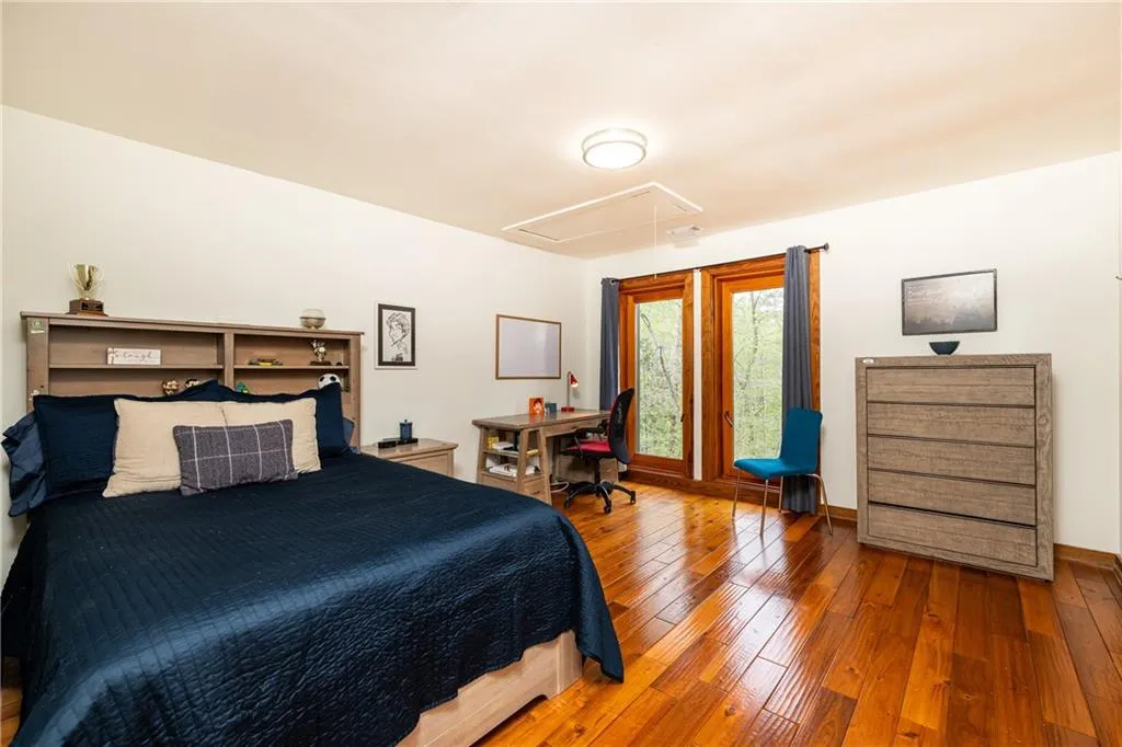 Bedroom with a desk and wood-type flooring