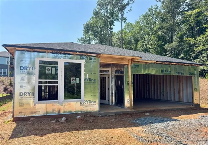 Single-story construction with attached garage, asphalt shingle roofing, and new windows