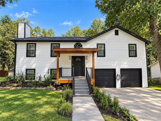 White siding exterior with black trim windows