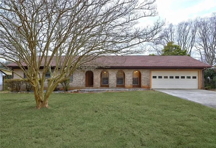 Brick facade with arched entryways and a two-car garage