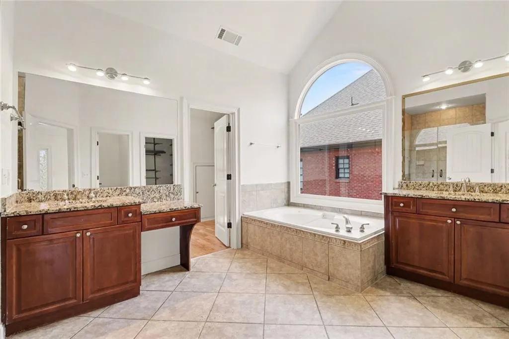 Primary Bath with Double Vanities, Tub, Large Tile Shower and Dual Walk-In Closets