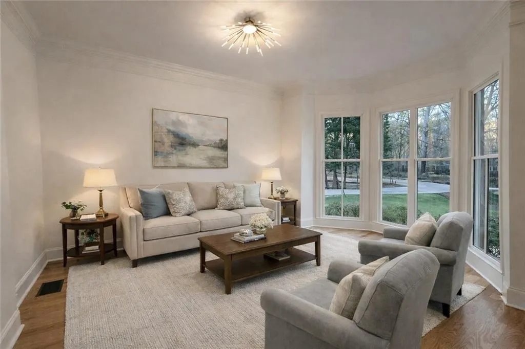 Living room featuring wood finished floors and crown molding