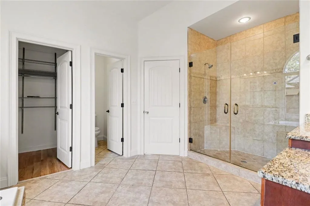 Primary Bath with Double Vanities, Tub, Large Tile Shower and Dual Walk-In Closets