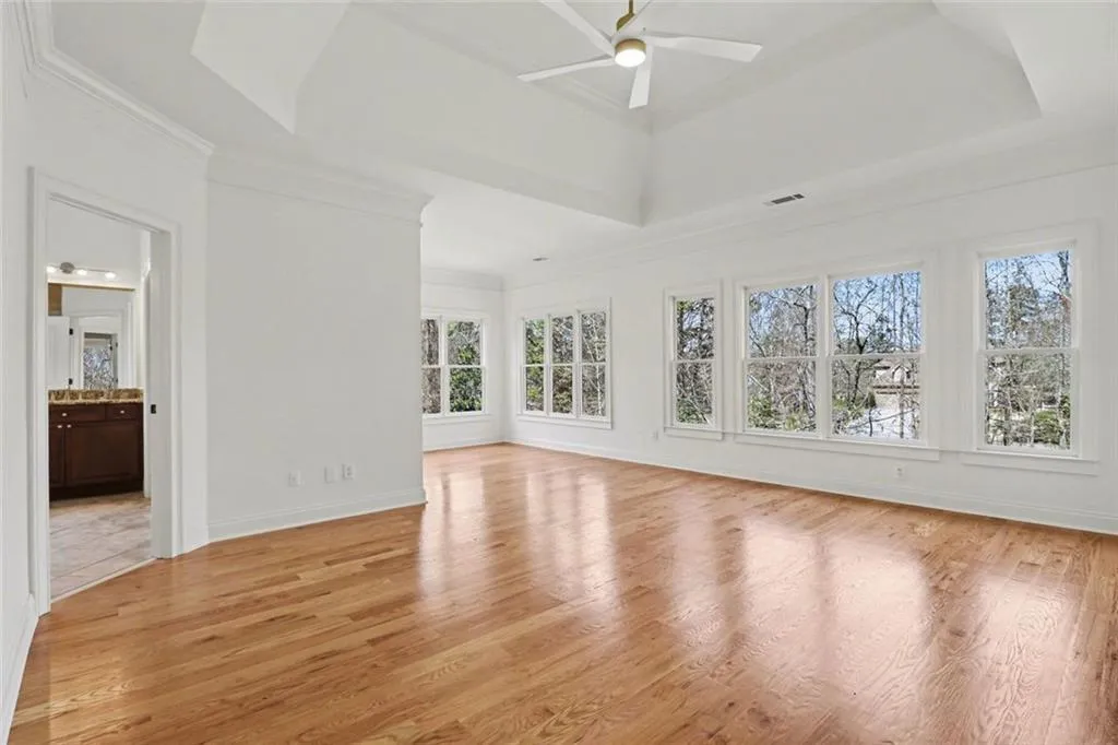 Oversized Primary Suite with Sitting Area, Vaulted Trey Ceiling, Wall of Windows Allowing Abundance of Natural Light
