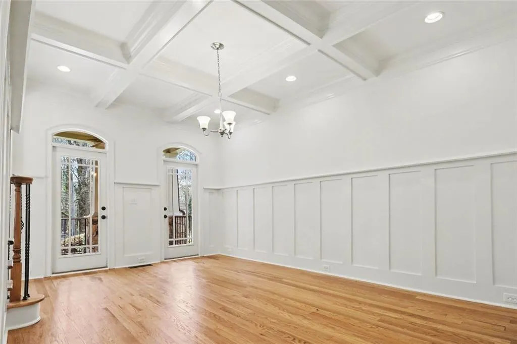 Dining Room with Coffered Ceiling & Double Doors Leading to Front Porch