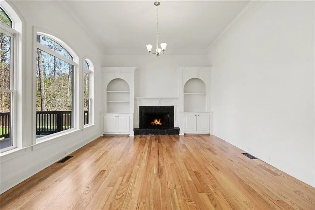 Family Room with Soaring 12-ft. Ceilings, Built-In BookCases, Fireplace & Arched Windows