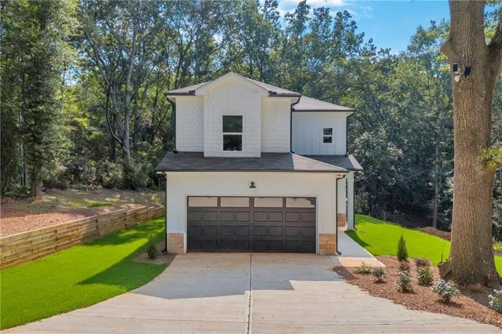 Modern two-story exterior with white siding and dark trim