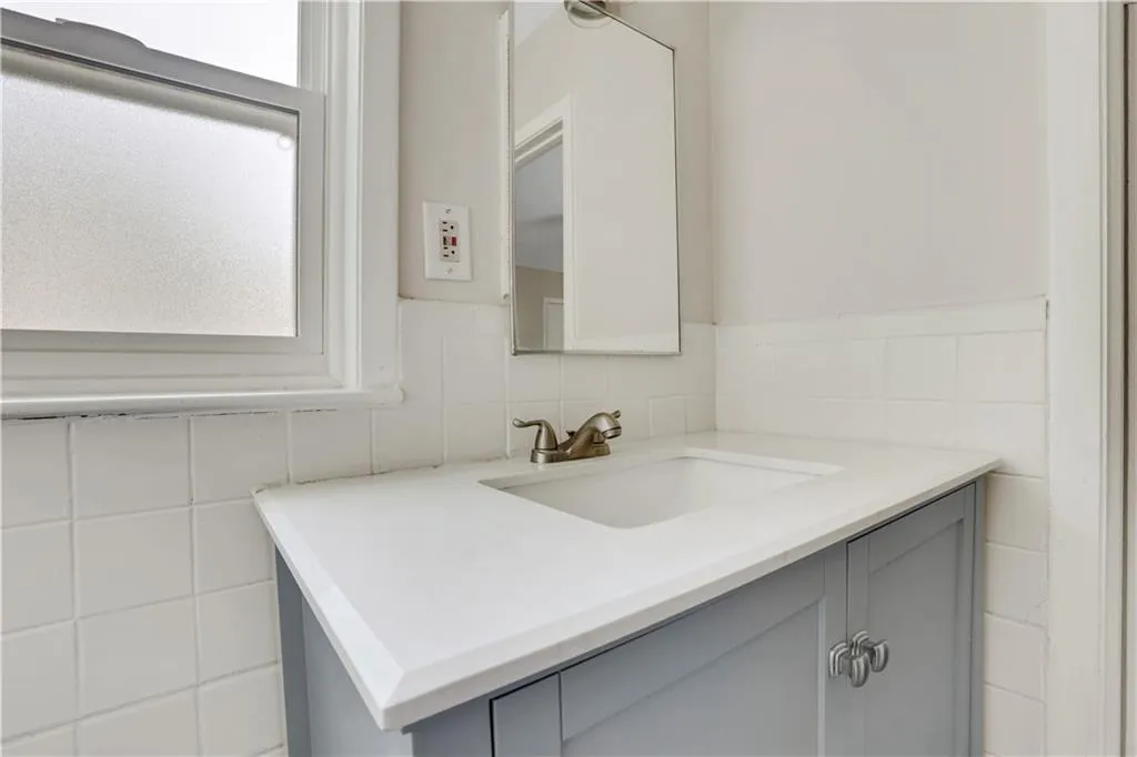 Bathroom with tile walls and vanity