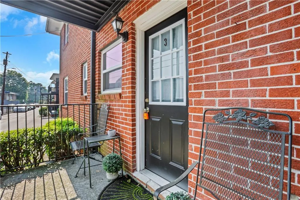 View of exterior entry with brick siding