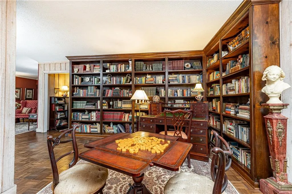 Enjoy this beautiful library with stately bookshelves in warm wood.