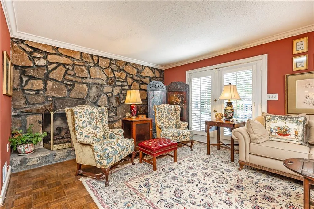 The bold, historic granite wall continues on the lower level featuring a fourth fireplace.