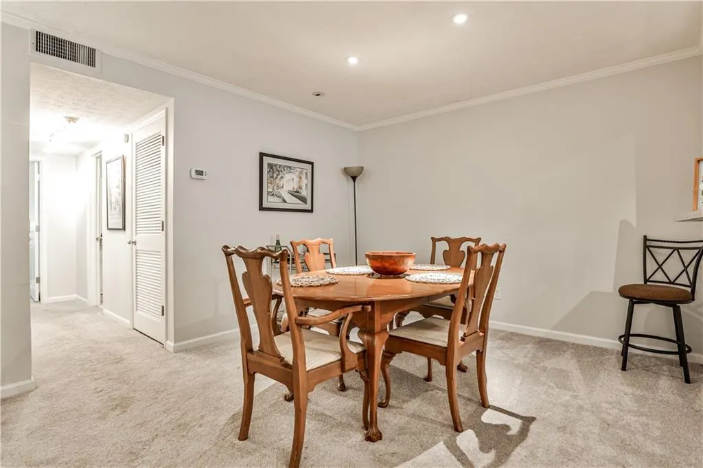 Dining room featuring light carpet and crown molding