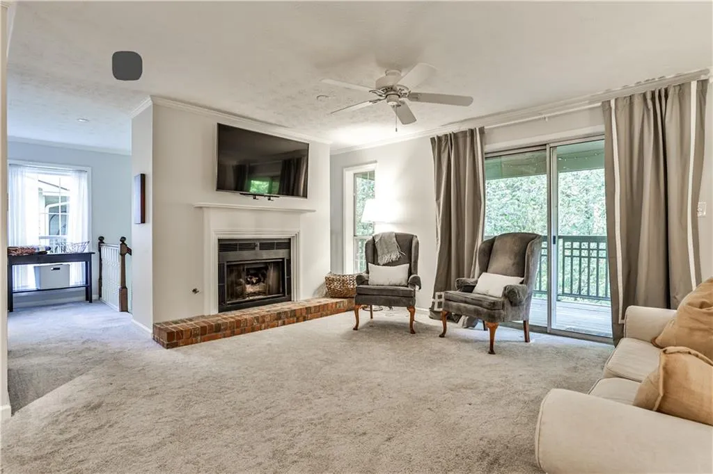 Sitting room featuring crown molding, carpet flooring, healthy amount of natural light, ceiling fan, and a textured ceiling