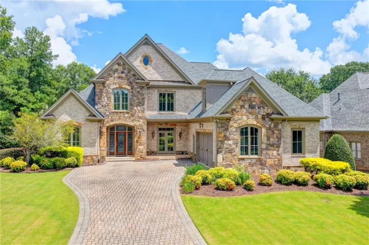 Stone and brick exterior with a multi-gabled roofline