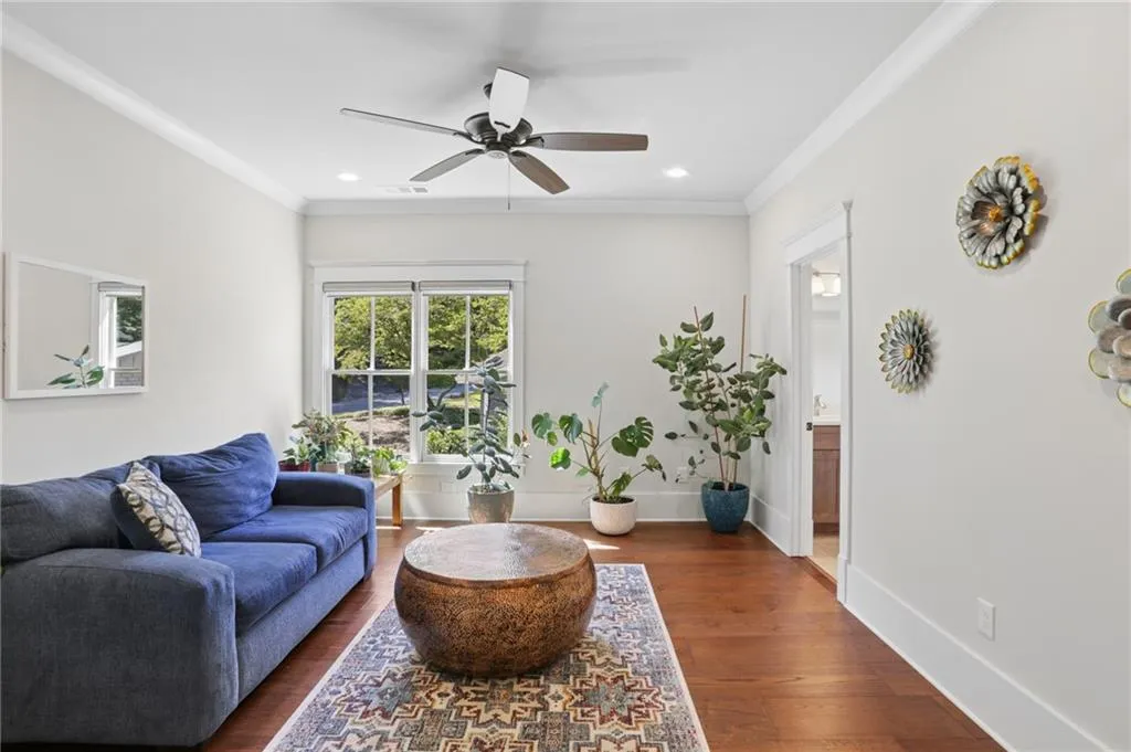 Upstairs Hardwood flooring, recessed lighting, crown molding, double-hung windows, and a ceiling fan