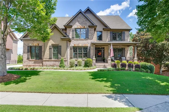 Beautiful brick and stone-accented home with mature landscaping and exceptional curb appeal.