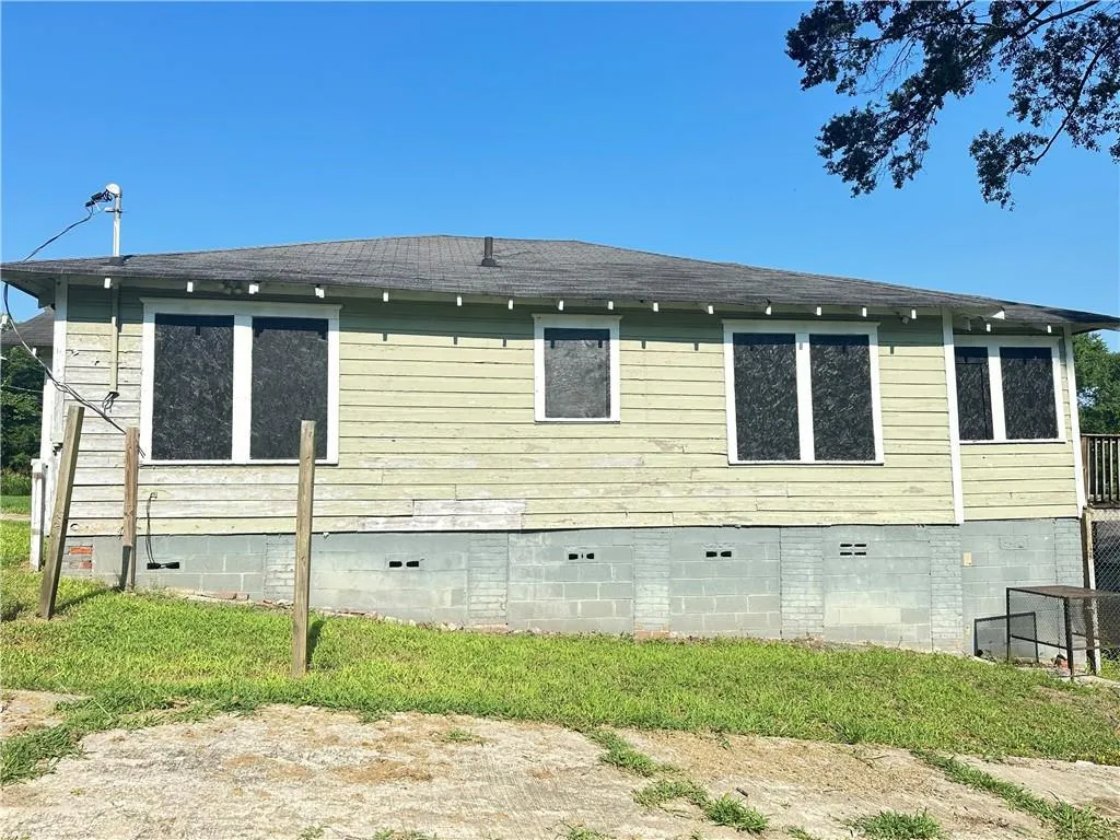 View of side of home with crawl space